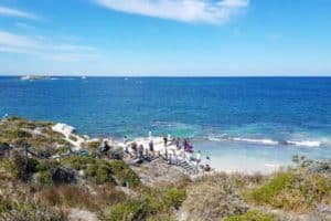 parker point rottnest island clear waters blue skies coastline people walking down to waters edge