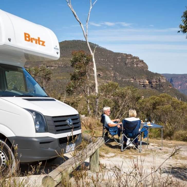Britz campervan with couple outside
