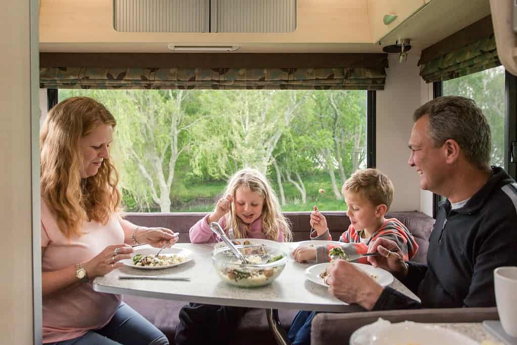 family eating in motorhome camping