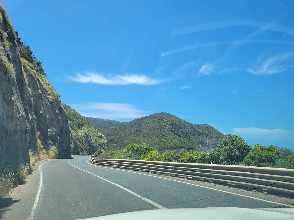 Winding section of the Great Ocean Road beneath coastal cliffs