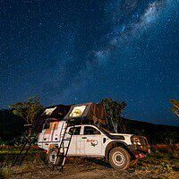4WD Camper With Rooftop Tent Under The Milky Way 4WD camper with a rooftop tent set up under the Milky Way at a bush campsite